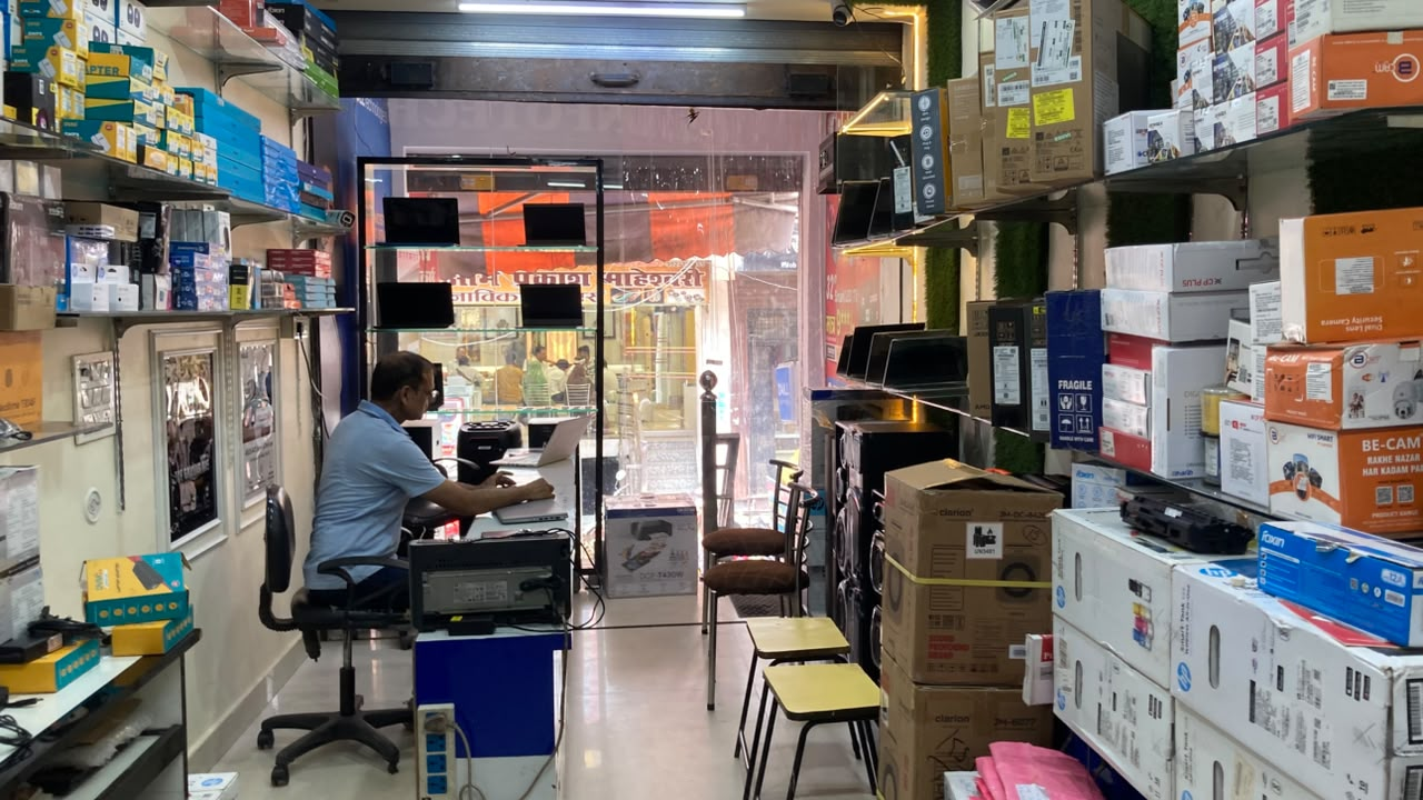 Inside Computer Bazar electronics shop in Kasganj with laptops, printers, CCTV and accessories in stock